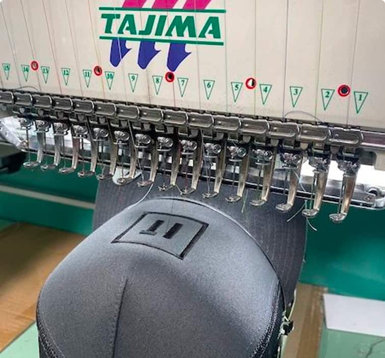 Tajima embroidery machine stitching a custom hat