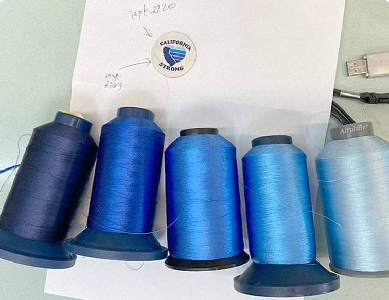 Embroidery thread spools matched to Pantone colors