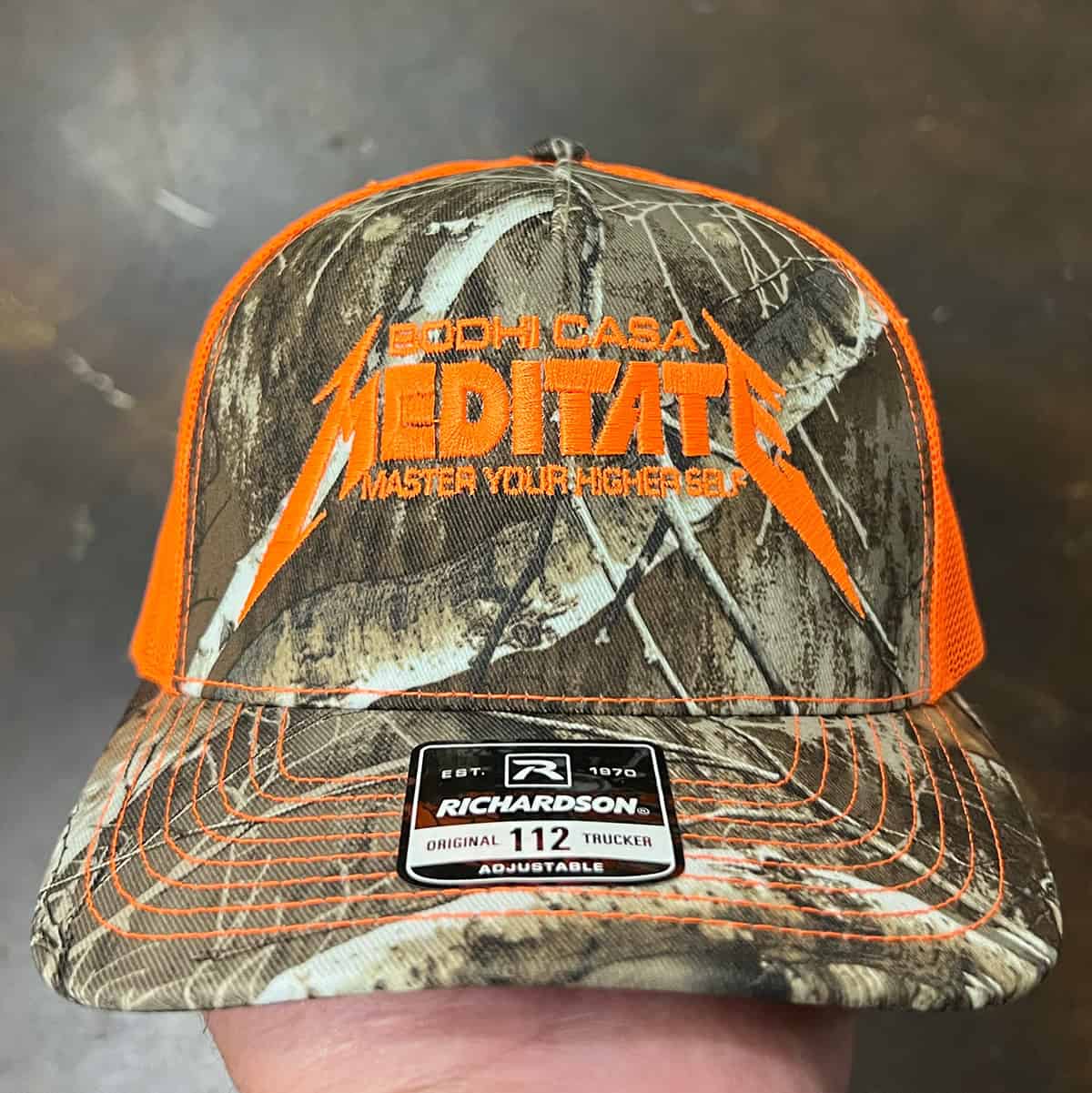 Richardson Blaze orange camo trucker hat with embroidered logo