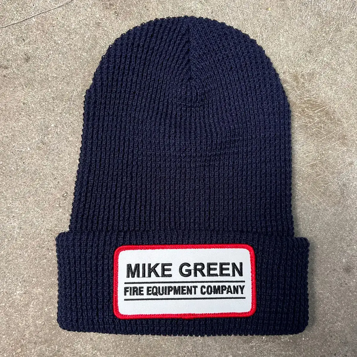 Embroidered patch sewn onto a cuffed beanie