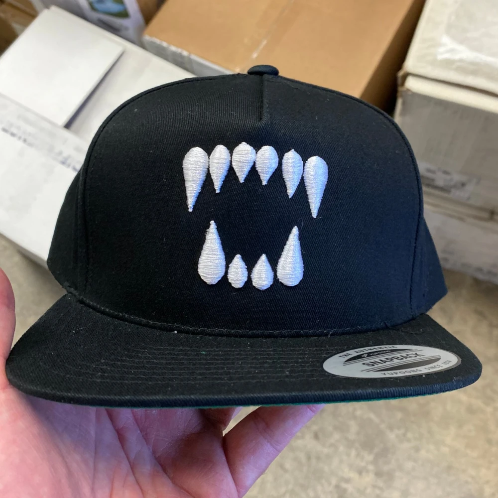 black yupoong 6007 flat bill snapback hat with white 3D puff embroidered fangs