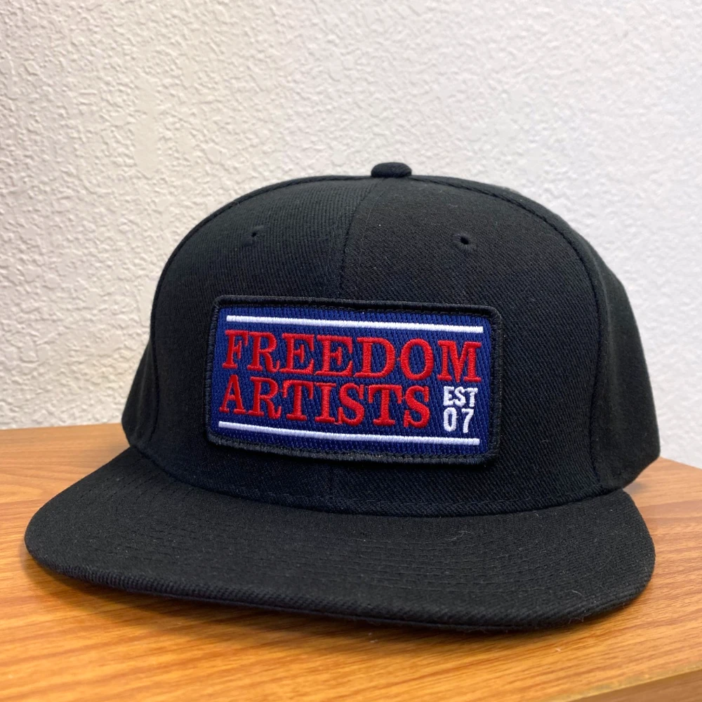 black Decky 6020 flat bill snapback hat with red white and blue embroidered patch