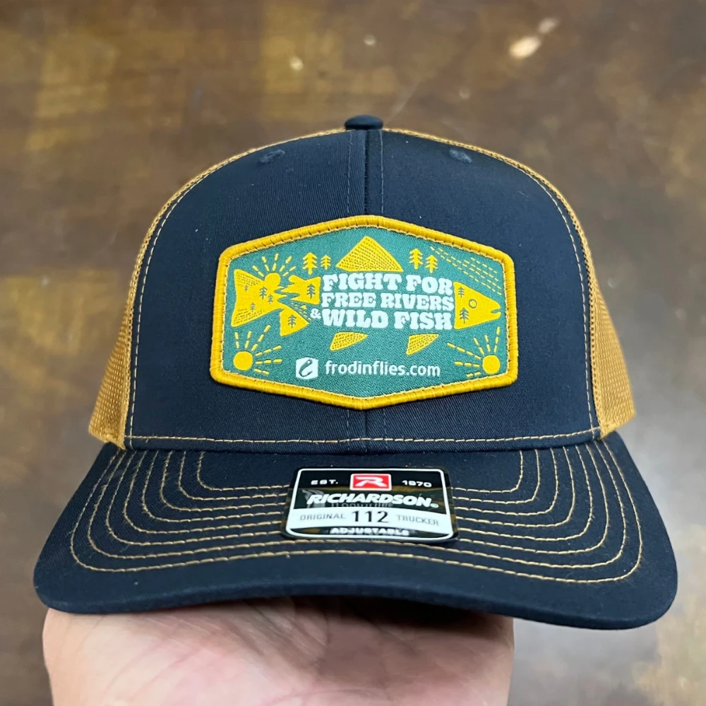 Navy and gold Richardson 112 trucker hat with woven patch
