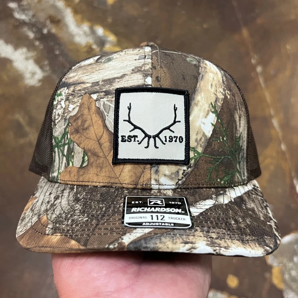 Realtree camo Richardson 112 trucker hat with embroidered antler patch