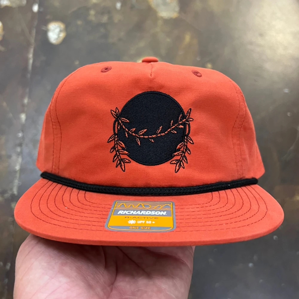 Burnt orange Richardson 256 rope cap with embroidered wreath design