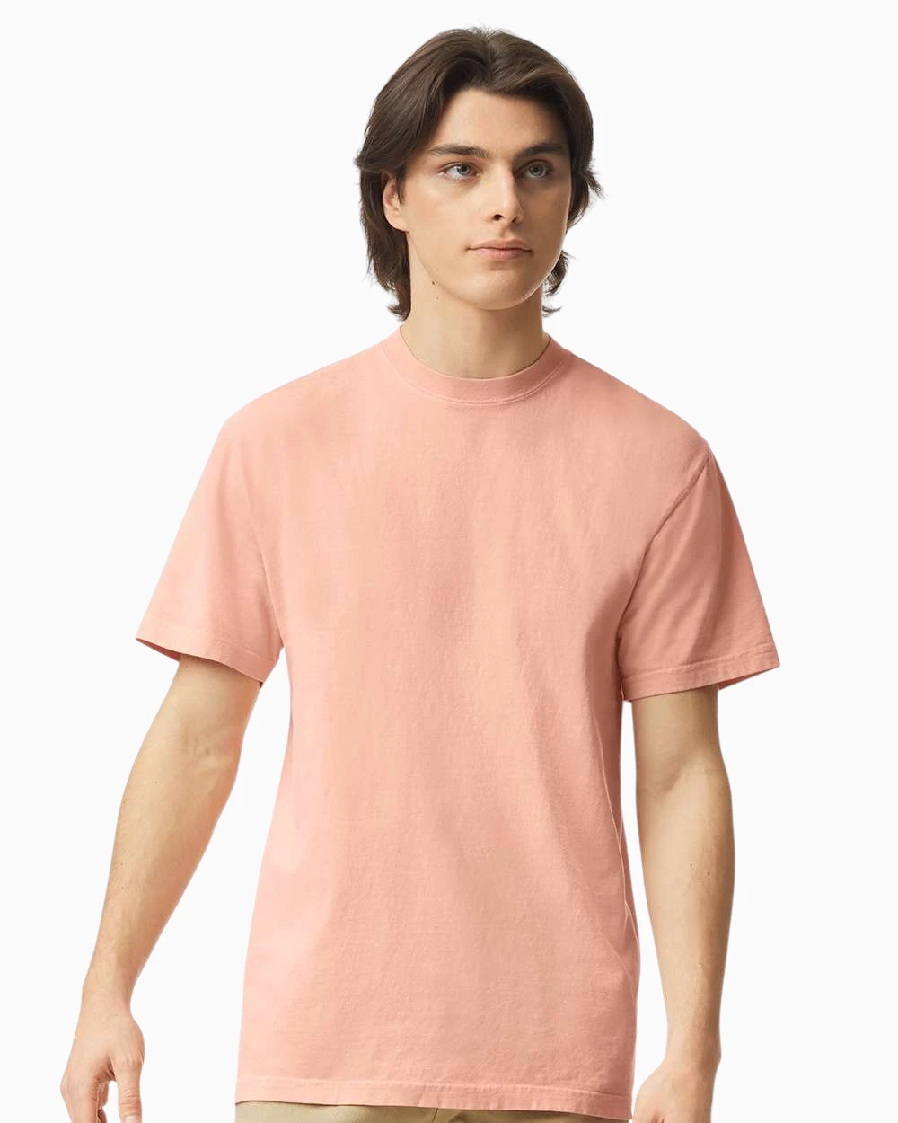 Model wearing a Comfort Colors 1717 garment-dyed t-shirt in peachy