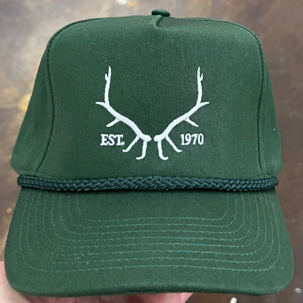 White antler logo embroidered on a green rope hat