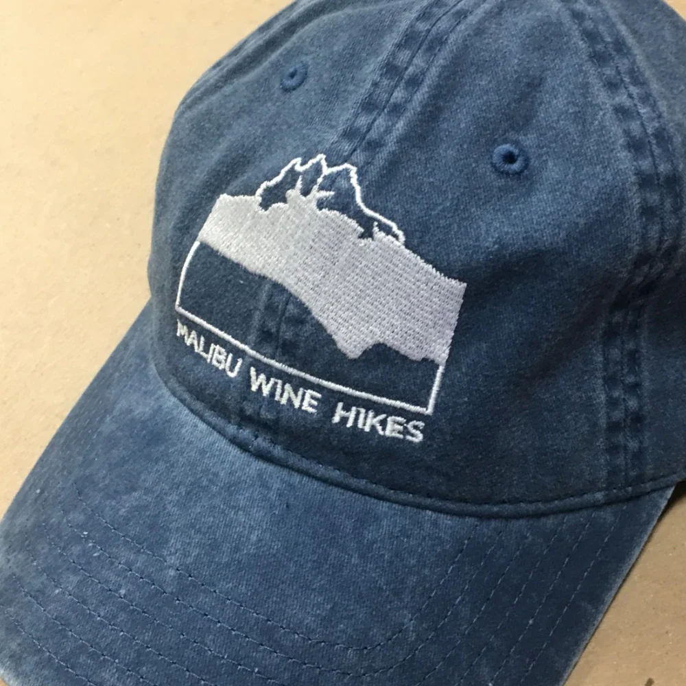 Mountain logo embroidered on a washed blue dad hat