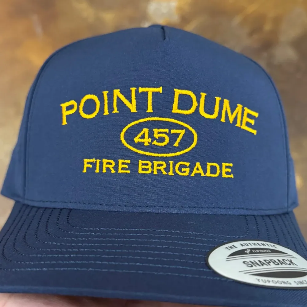 Gold text logo embroidered on a navy snapback