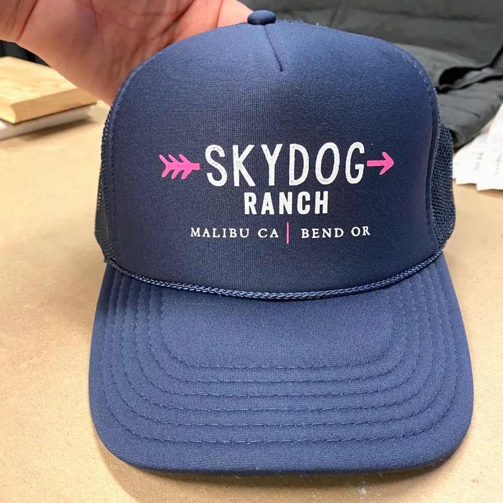 Navy Otto Cap 39-165 foam front trucker hat with white and pink printed logo