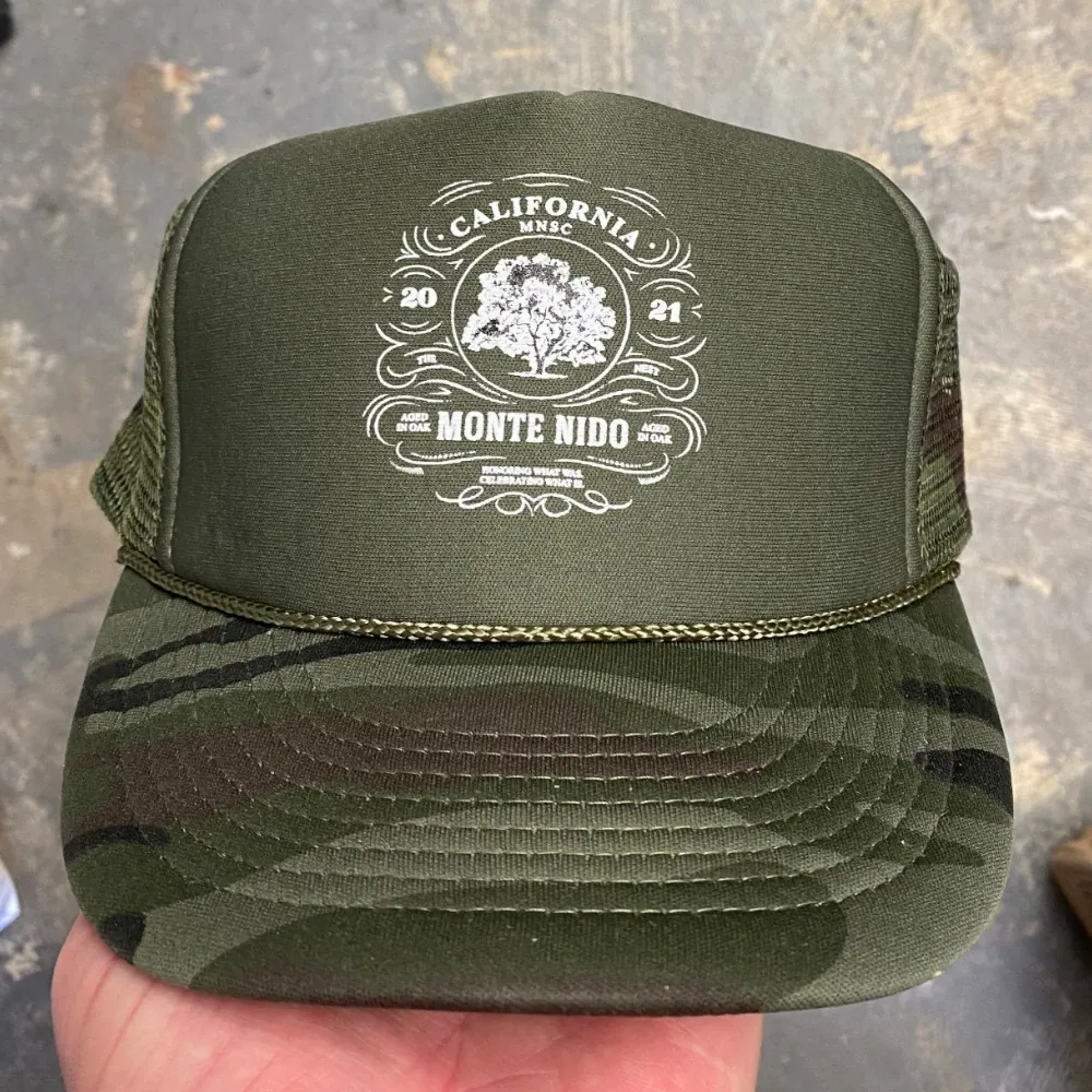 Olive and camo Otto Cap foam front trucker hat with white printed logo